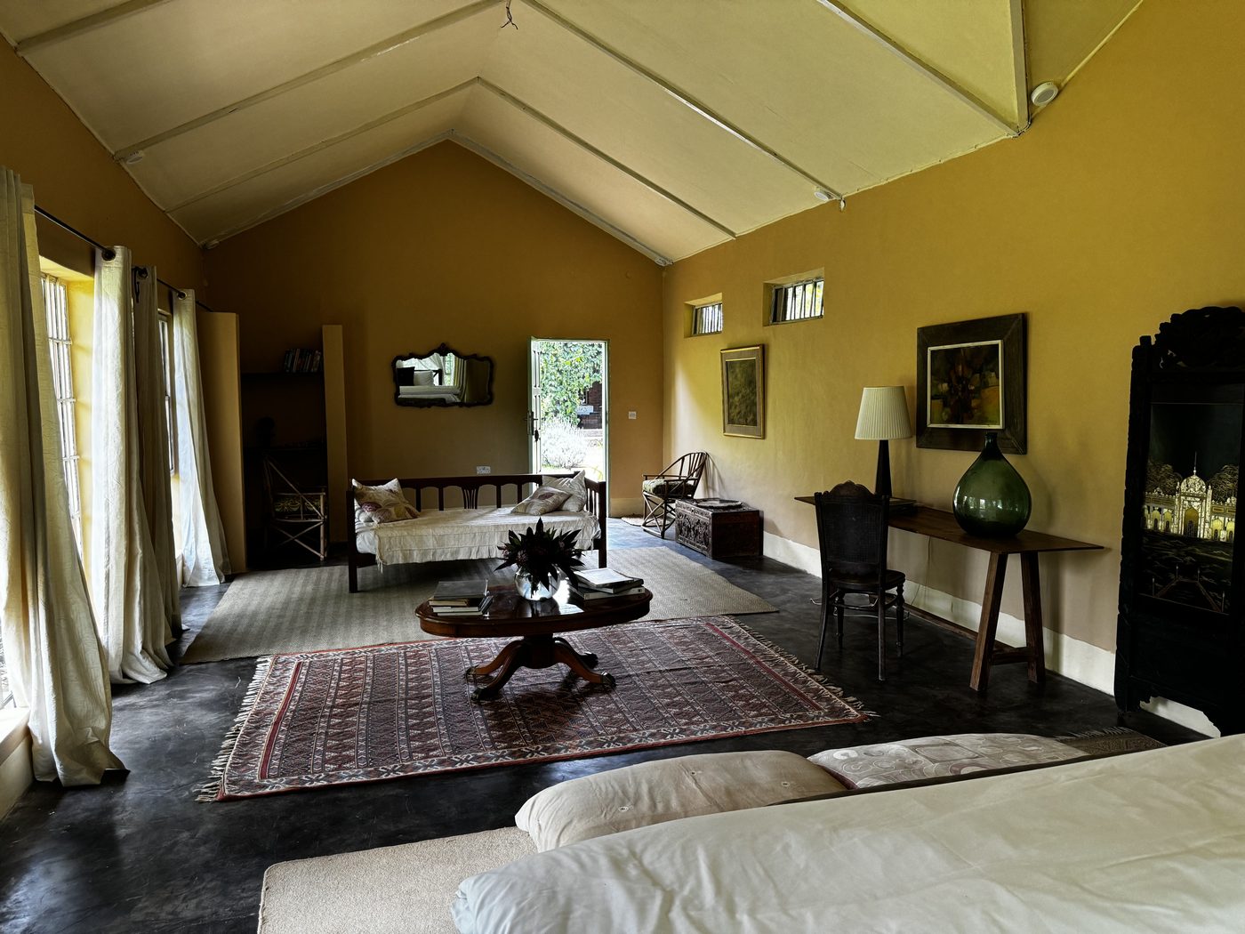 Pool Cottage from the bed — daybed by open French doors looking onto the garden